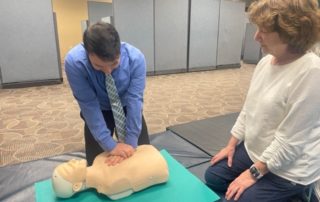 A PAM Health employee learns CPR as a certified instructor provides direction.